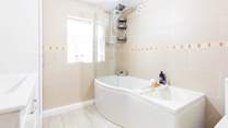 A generous family bathroom that sits on a half-landing before you head up to bedrooms 1 and 2.