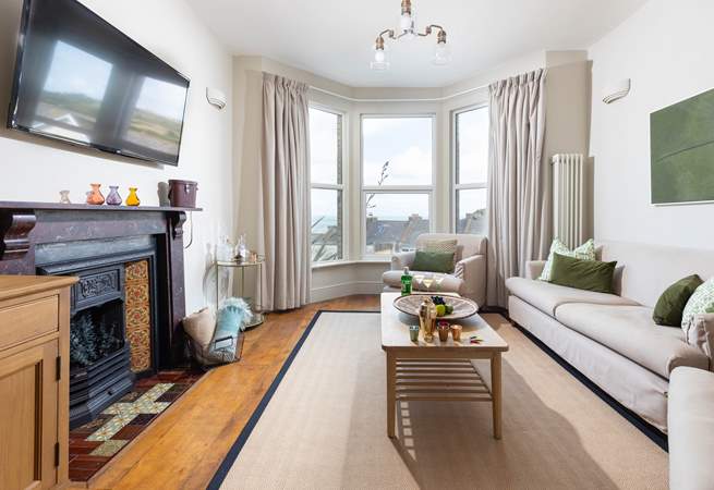 The sitting-room looks out to the sea, however by night this gorgeous room offers the perfect spot for evening drinks followed by a movie night. 