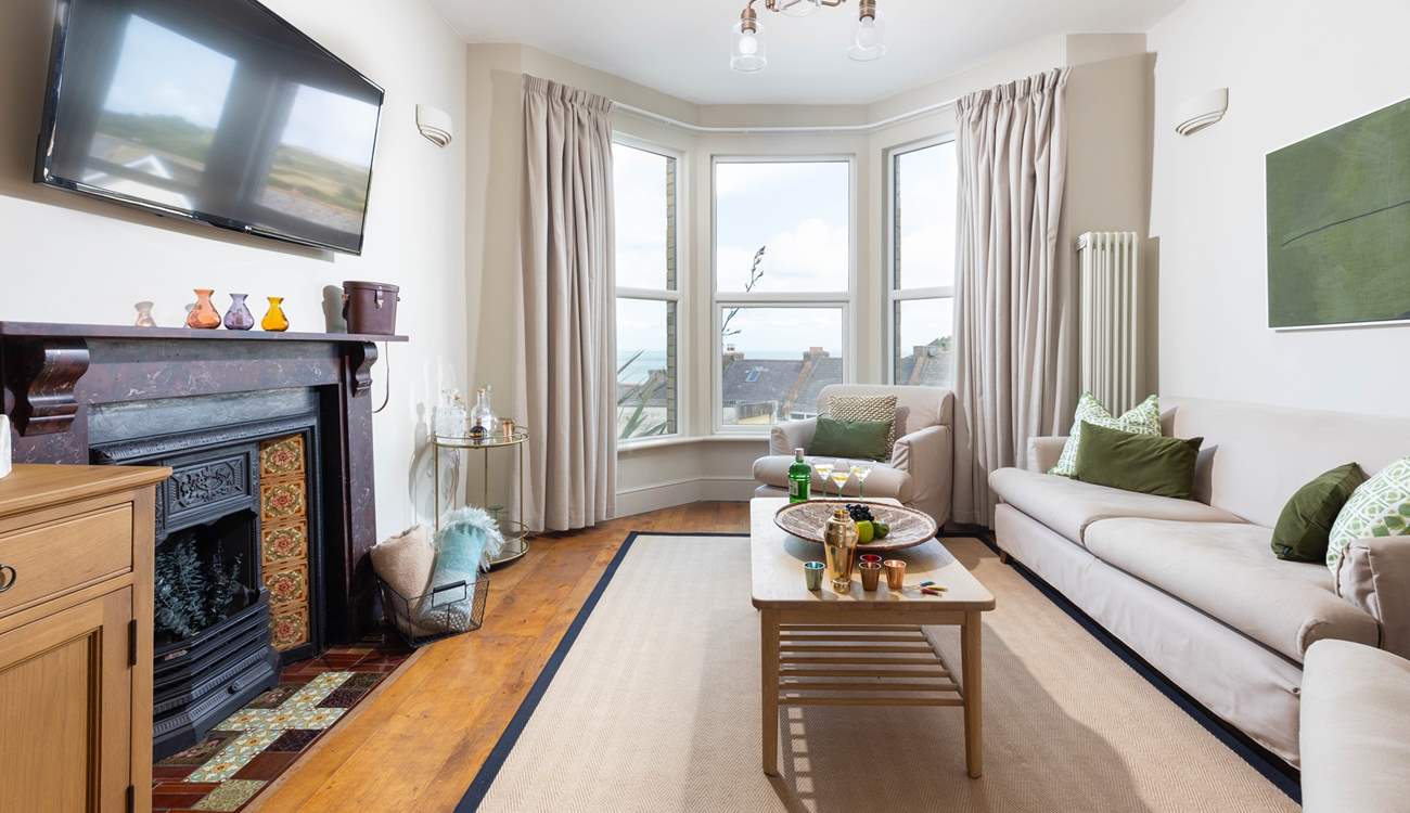 The sitting-room looks out to the sea, however by night this gorgeous room offers the perfect spot for evening drinks followed by a movie night. 