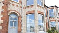 No 12 sits on a terraced street, climb the steps up to the front door.