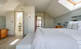 Relax in the light and airy main bedroom. - Thumbnail Image