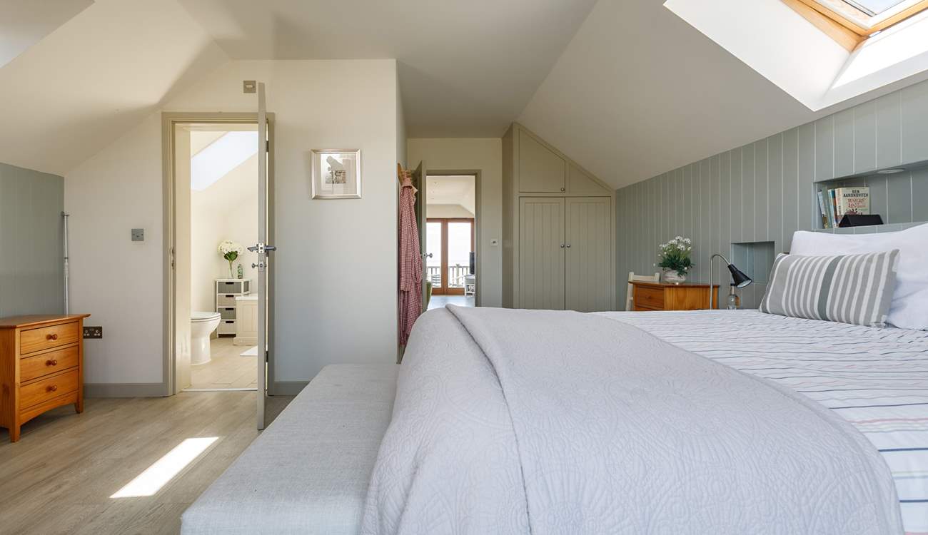 Relax in the light and airy main bedroom.