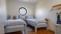 A nautical twin room, what can you see from the round window today?