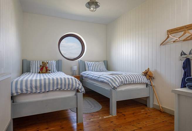 A nautical twin room, what can you see from the round window today?