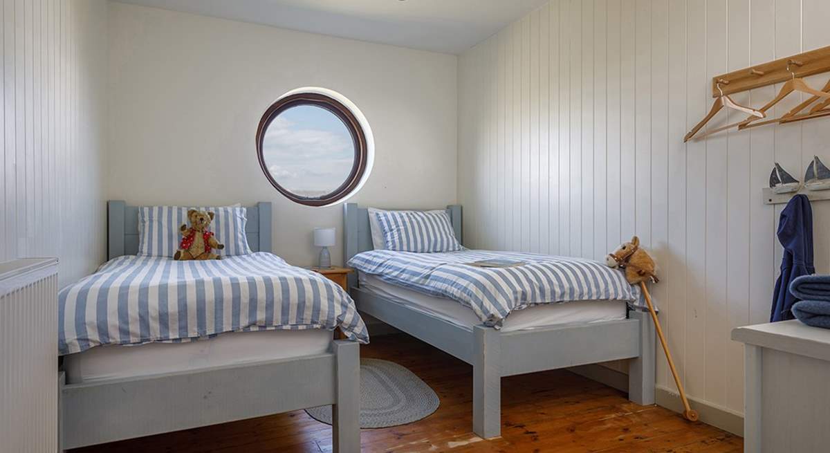 A nautical twin room, what can you see from the round window today?