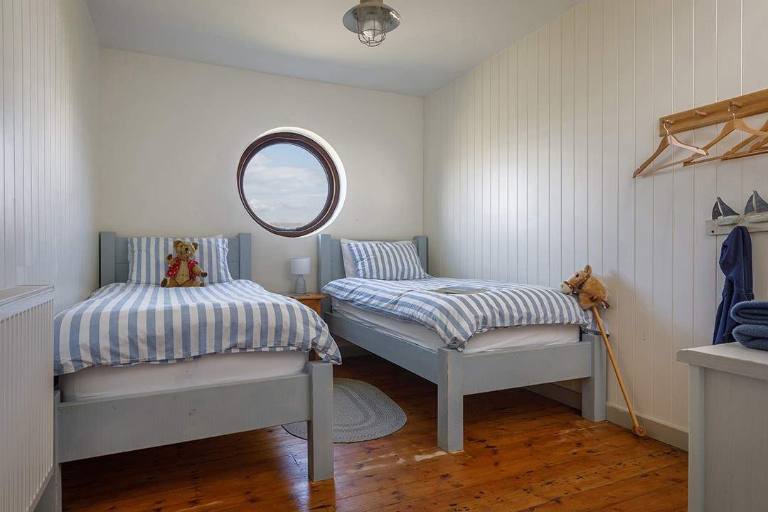 A nautical twin room, what can you see from the round window today?