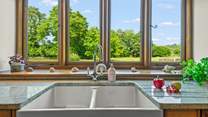 Even though there is a dishwasher, washing up by hand won't prove such a chore with these magical views.