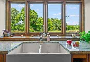 Even though there is a dishwasher, washing up by hand won't prove such a chore with these magical views.