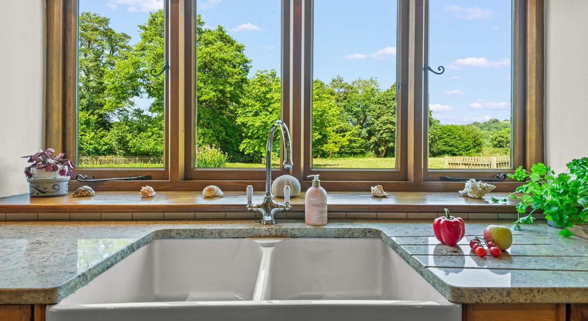 Even though there is a dishwasher, washing up by hand won't prove such a chore with these magical views.