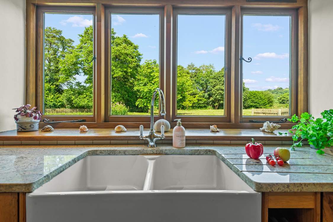 Even though there is a dishwasher, washing up by hand won't prove such a chore with these magical views.