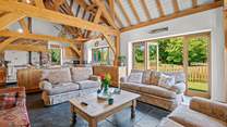 The open plan kitchen/dining-room also offers this fabulous comfy seating-area, which conveniently also opens out onto the patio area.