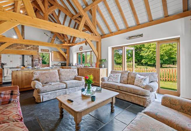 The open plan kitchen/dining-room also offers this fabulous comfy seating-area, which conveniently also opens out onto the patio area.