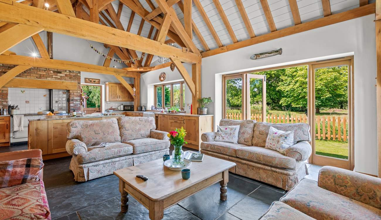 The open plan kitchen/dining-room also offers this fabulous comfy seating-area, which conveniently also opens out onto the patio area.