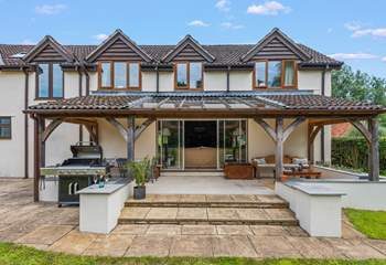 Step out of the sitting-room onto the covered verandah area.