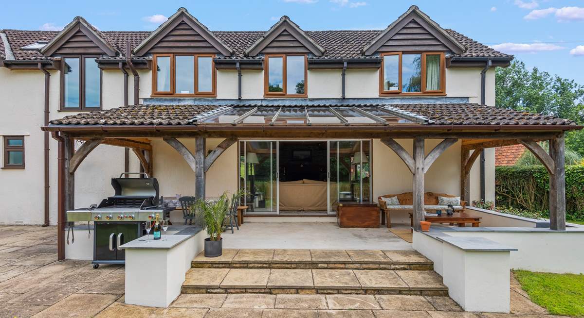 Step out of the sitting-room onto the covered verandah area.