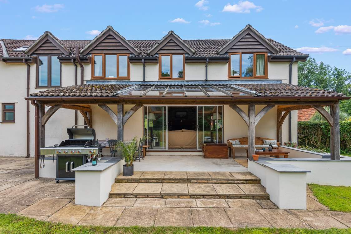 Step out of the sitting-room onto the covered verandah area.