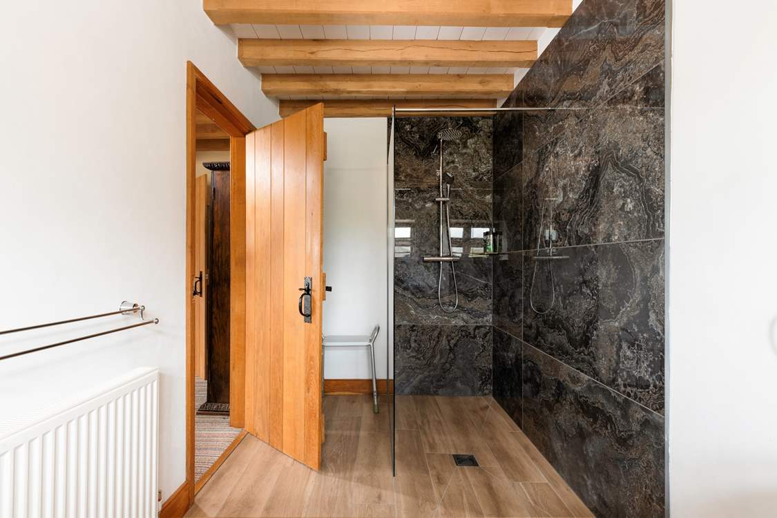 The spacious en suite shower-room is beautifully fitted out.