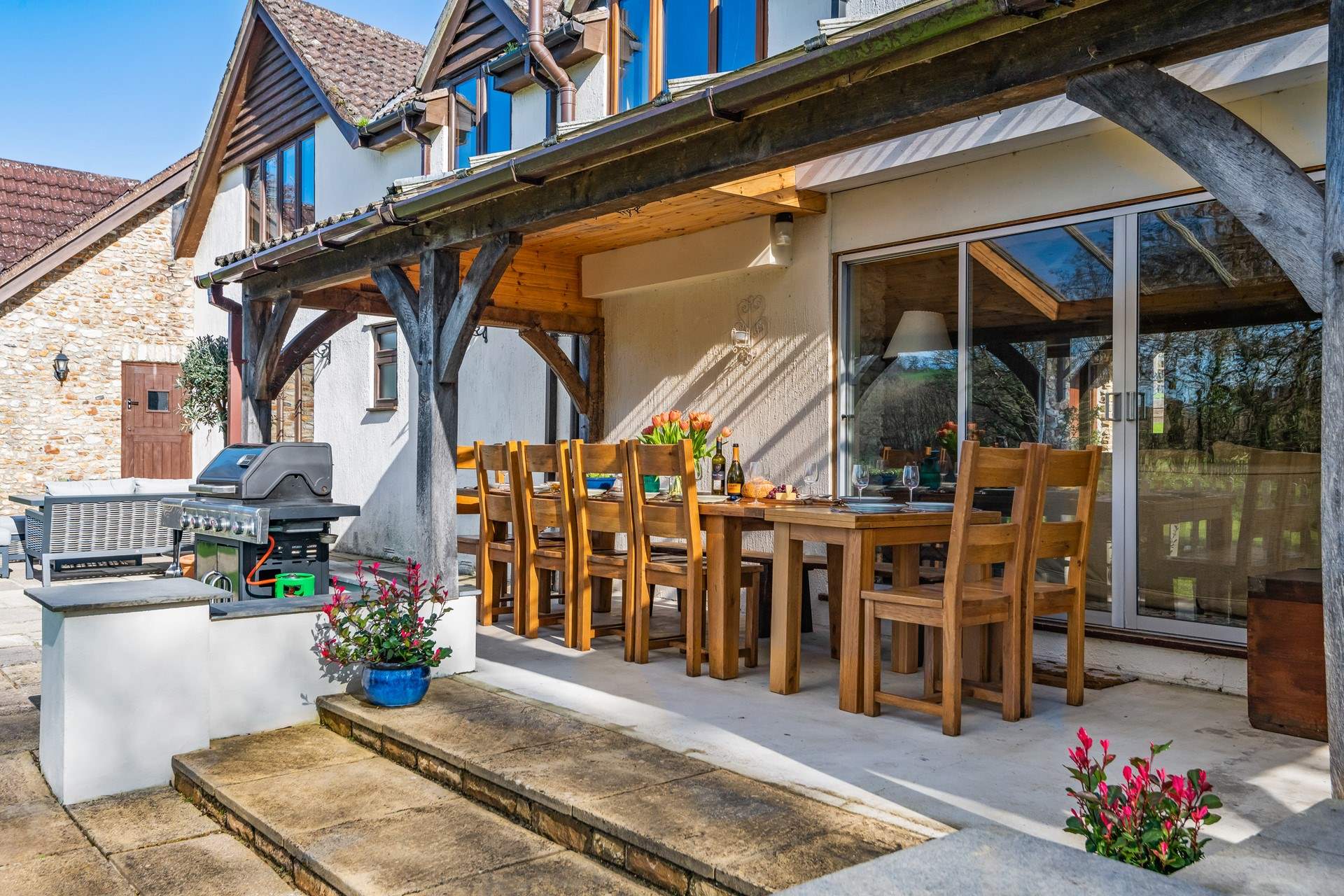 Step out of the sitting-room onto the covered verandah area.
