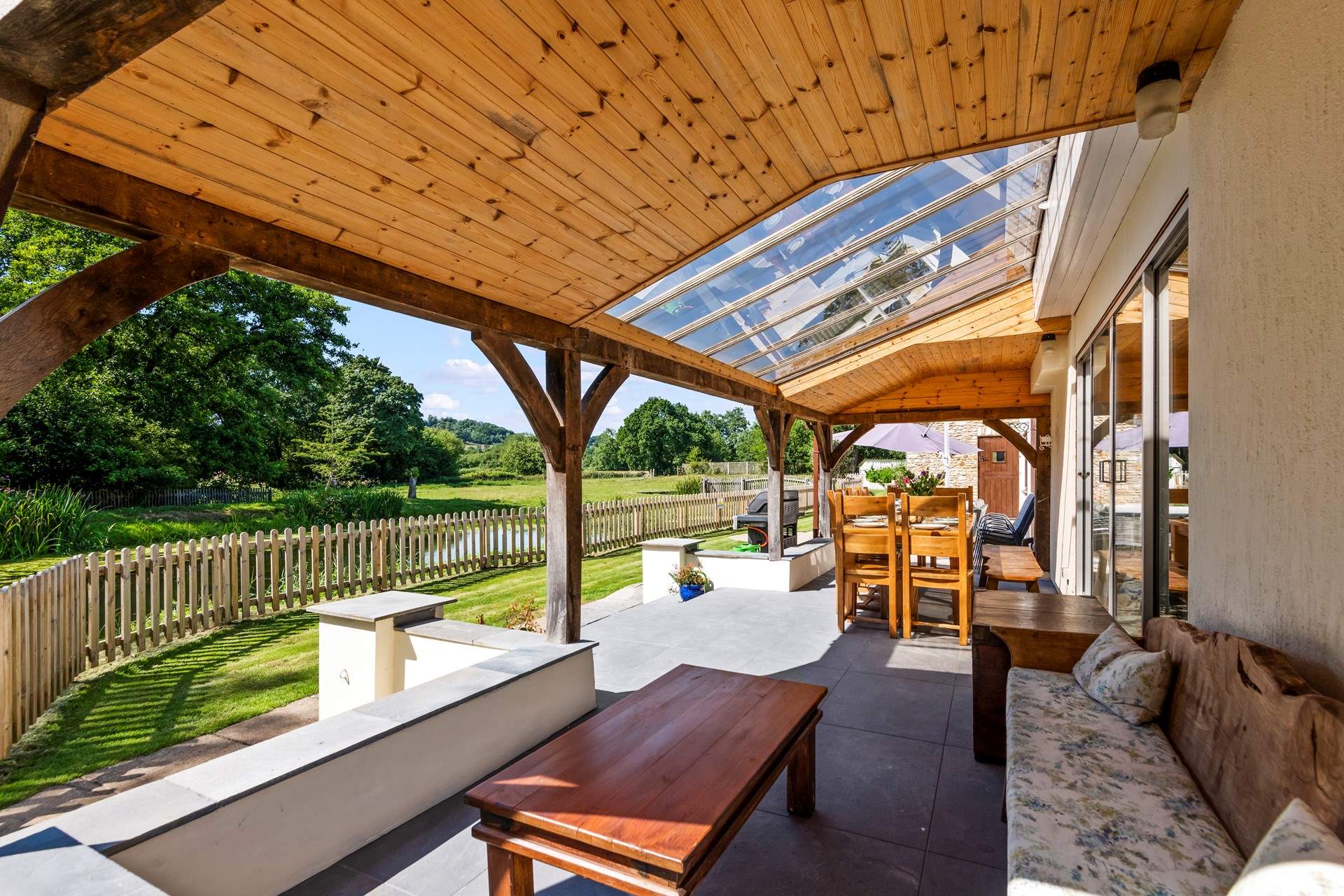 Step out of the sitting-room onto the covered verandah area.