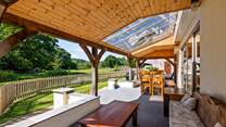Step out of the sitting-room onto the covered verandah area.