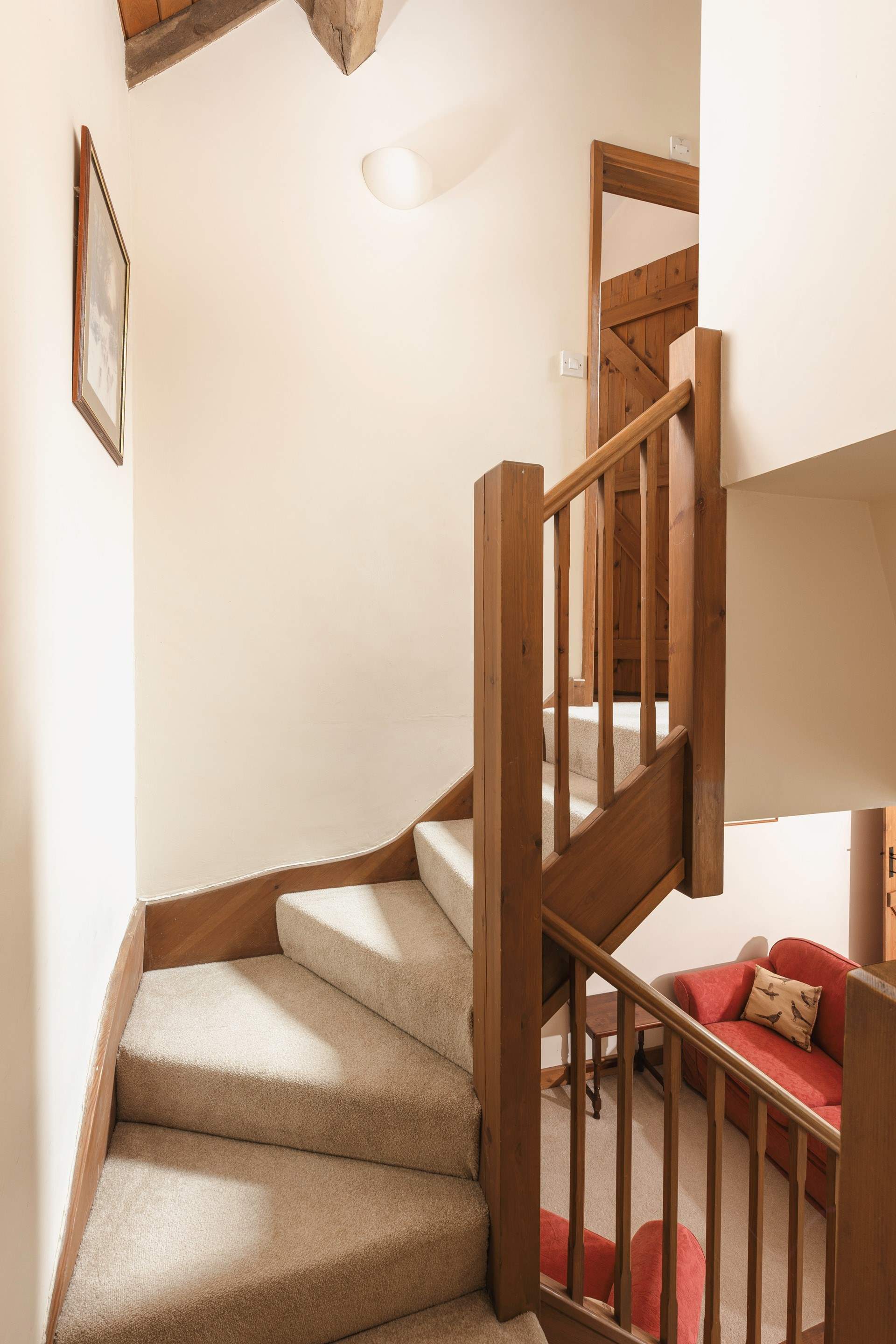 There is a winding staircase leading upstairs.