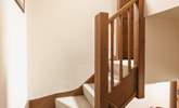 There is a winding staircase leading upstairs. - Thumbnail Image