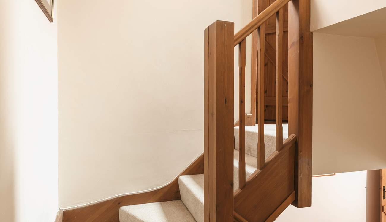 There is a winding staircase leading upstairs.