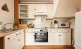 The cottage style kitchen is fully equipped for all your culinary needs. - Thumbnail Image