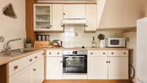 The cottage style kitchen is fully equipped for all your culinary needs.