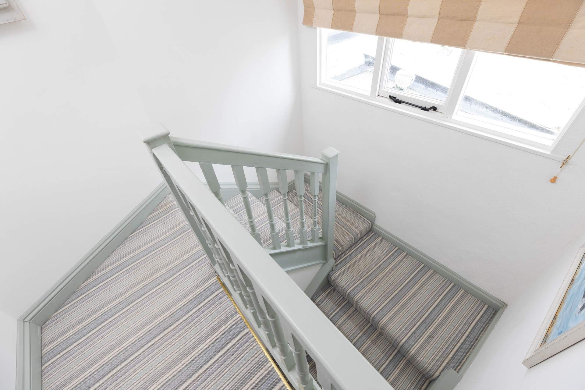 The turning staircase leads to the first floor bedrooms and bathroom. 