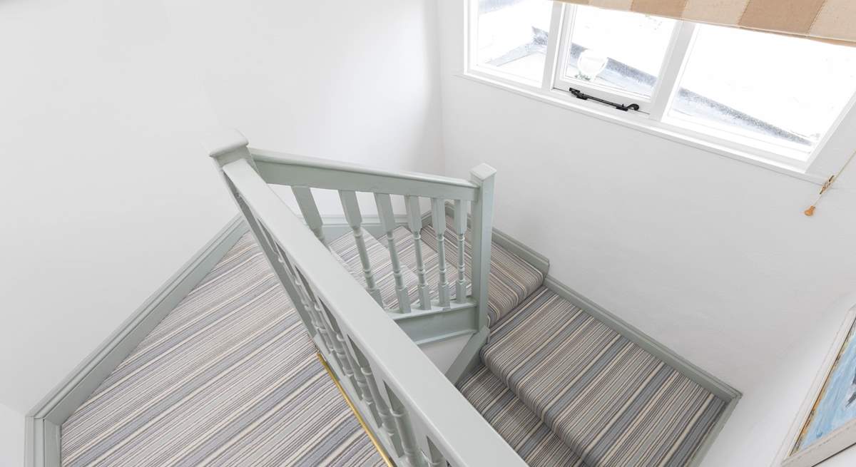 The turning staircase leads to the first floor bedrooms and bathroom. 