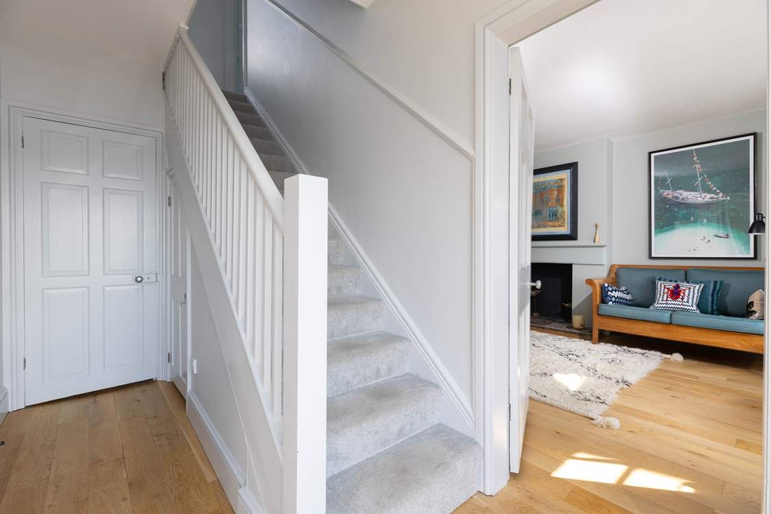 Stairs lead from the hall to the first floor.