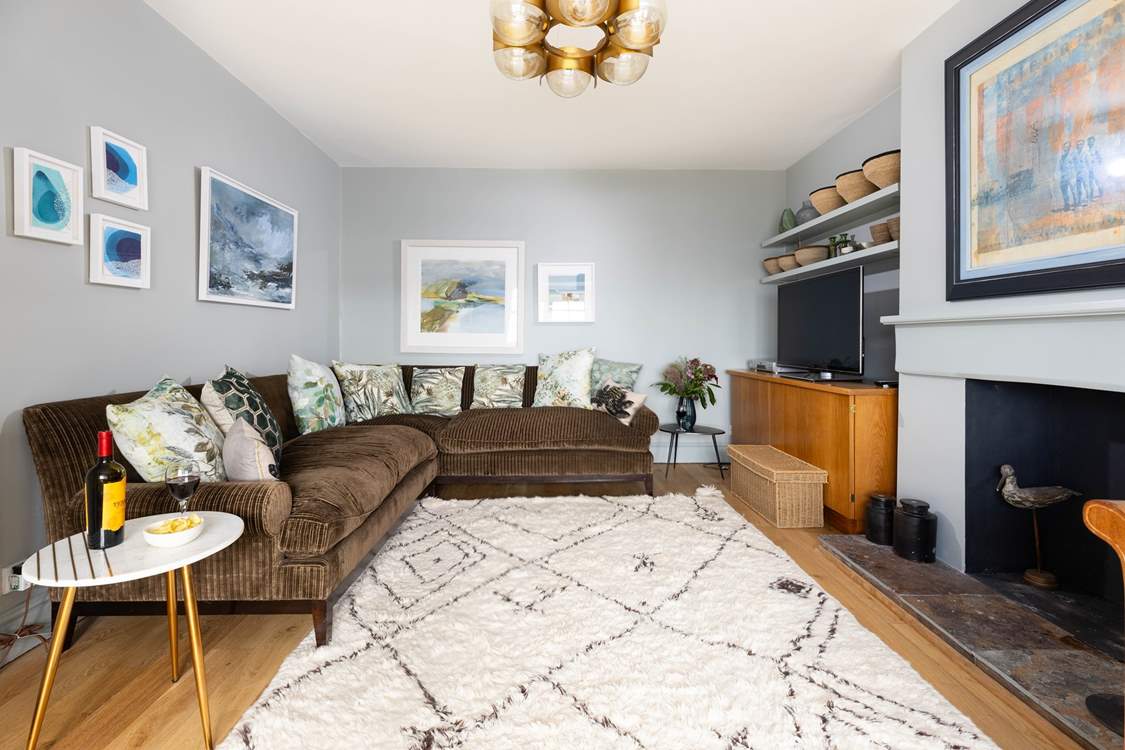 The large, comfortable sofa awaits, ideal for cosy evenings in.