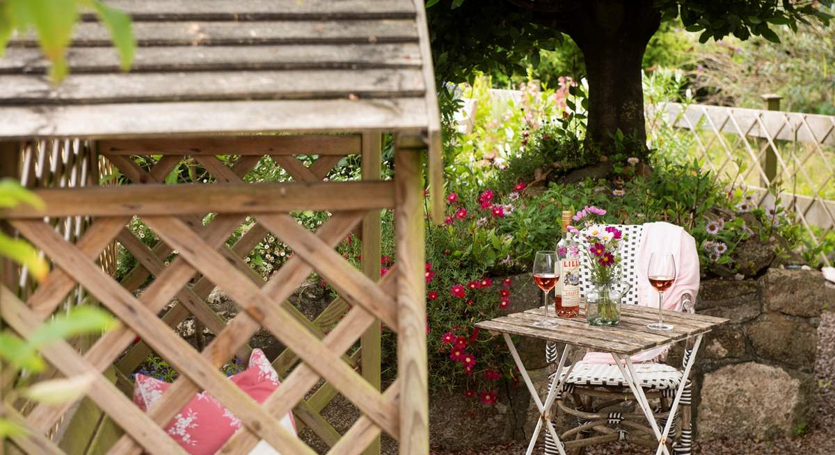 Enjoy a glass of wine outside in the pretty garden.