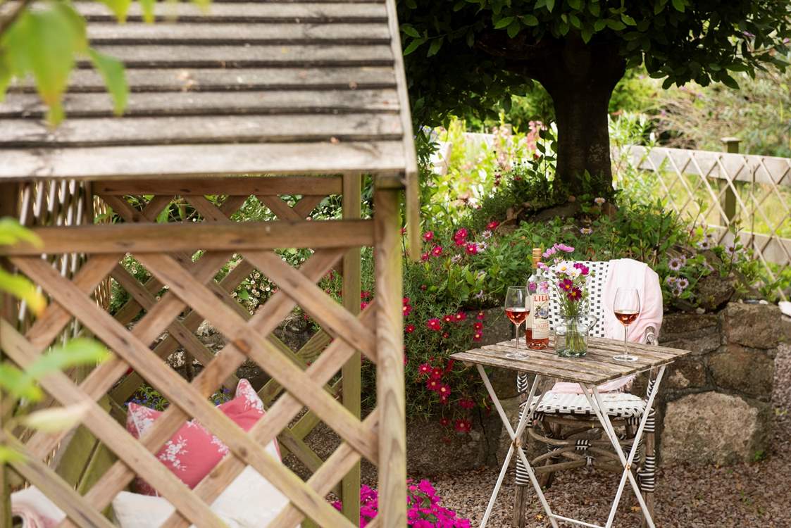 Enjoy a glass of wine outside in the pretty garden.