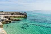 Crystal clear turquoise blue waters in St Ives, a swimmer's paradise.