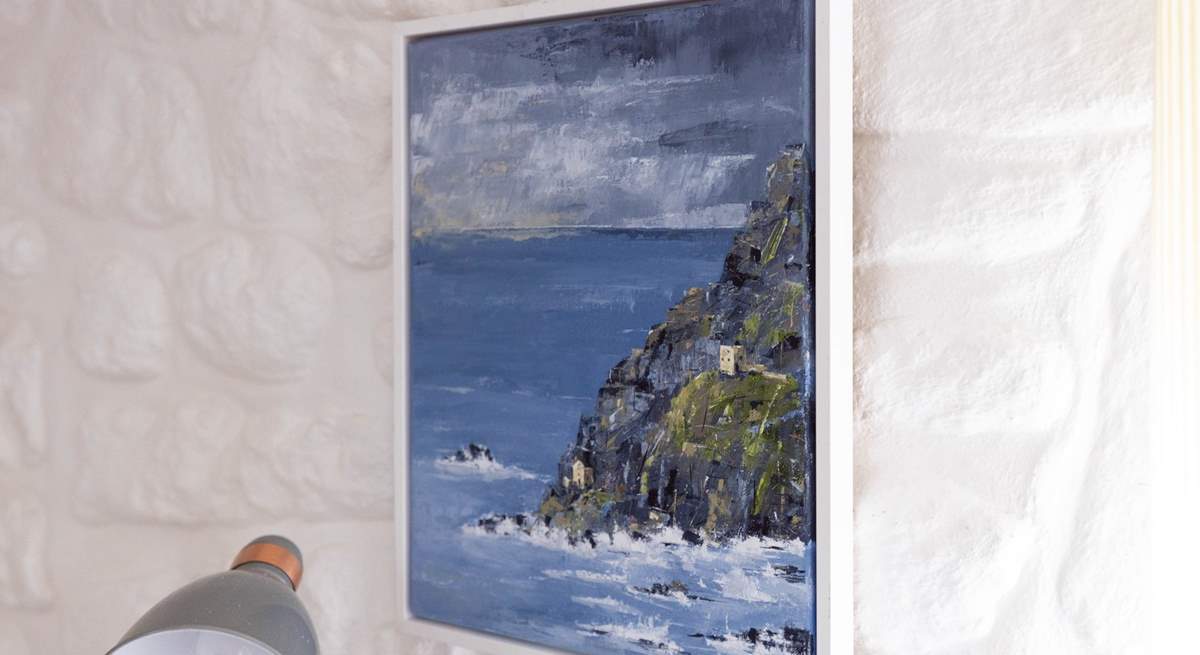 Whitewashed stone walls highlight the owner's artwork. 