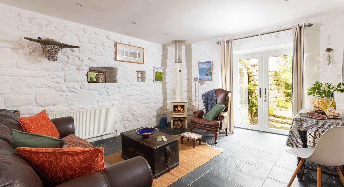 Such a cosy open plan living and dining area, with doors leading to the sweet garden.