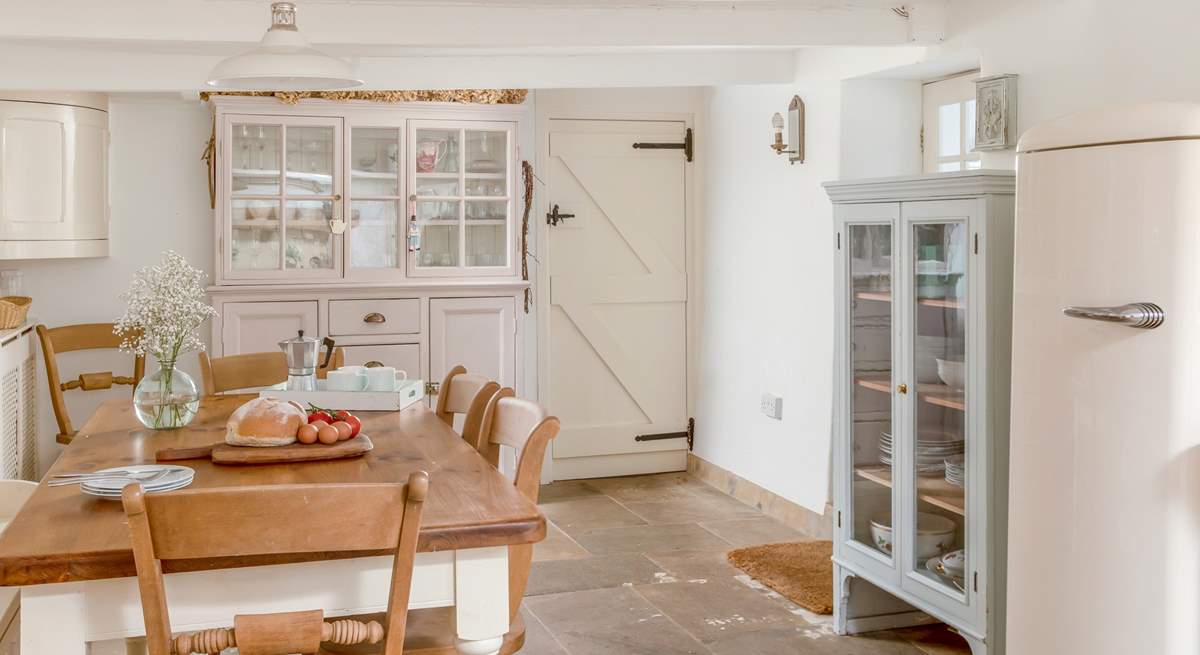 The kitchen/diner leads through to the sitting-rooms, the stairs to the bedrooms and a front door out to the porch. 