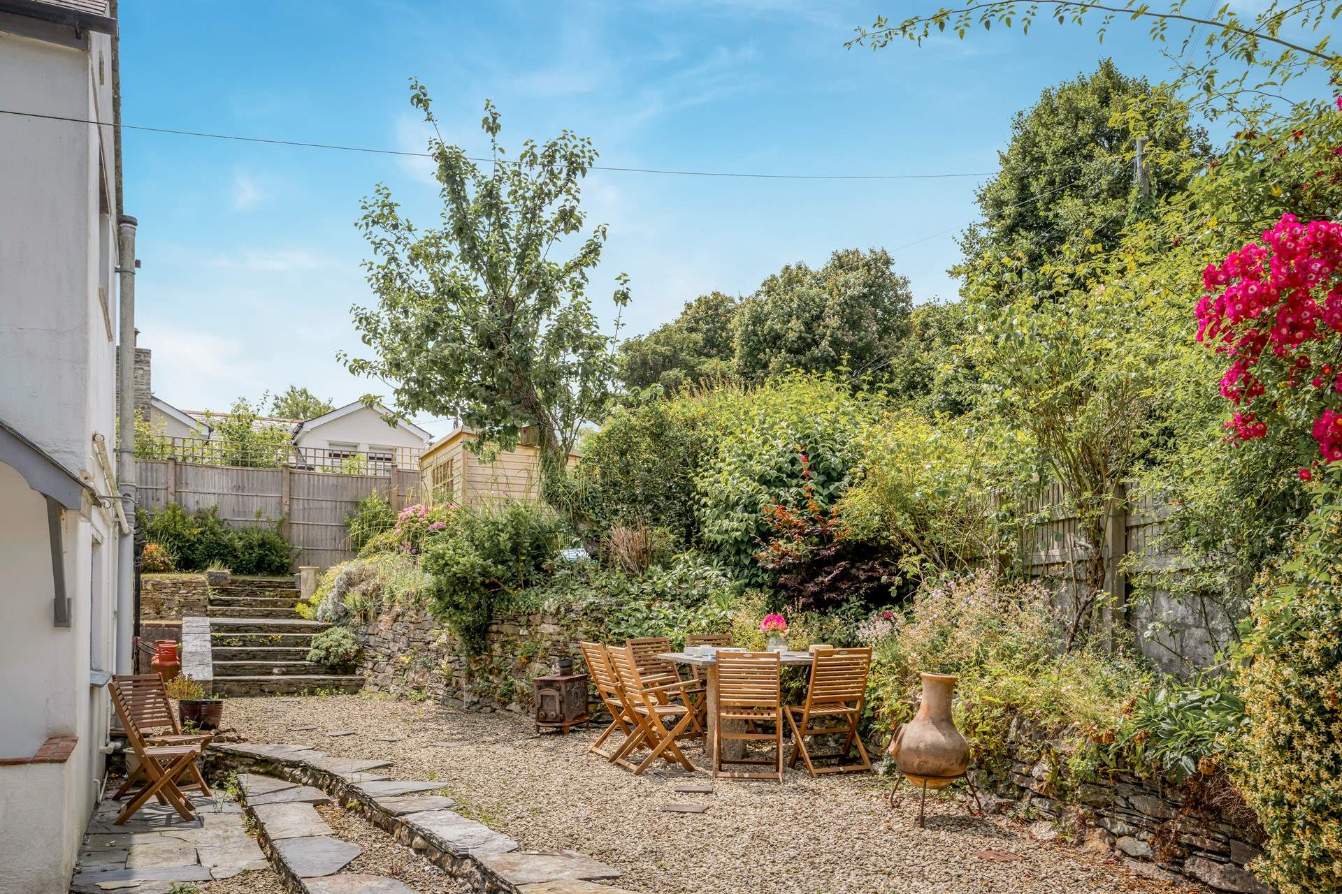 The back of the cottage is a sunny spot and has lots of space for everyone to relax. Please take care on the steps. 