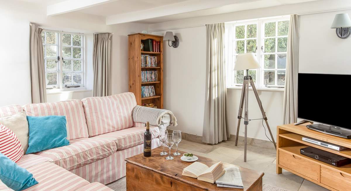 This pretty sitting-room has a cosy wood-burner to snuggle up in front of with a good film. 