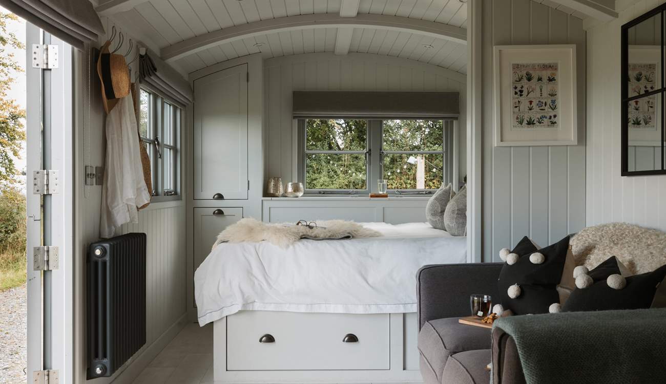 The comfy king-size bed is the perfect place for your morning coffee.