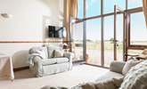 Enjoy the hugely impressive view through the floor-to-ceiling window to the immediate and distant fields and countryside. - Thumbnail Image