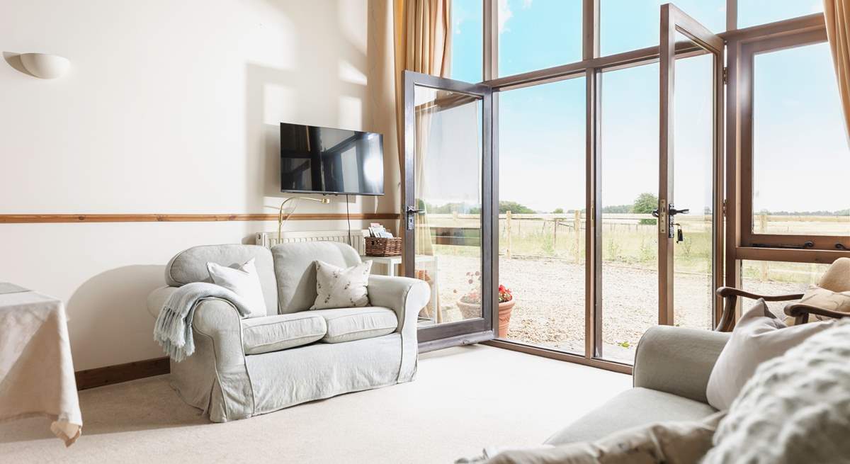 Enjoy the hugely impressive view through the floor-to-ceiling window to the immediate and distant fields and countryside.