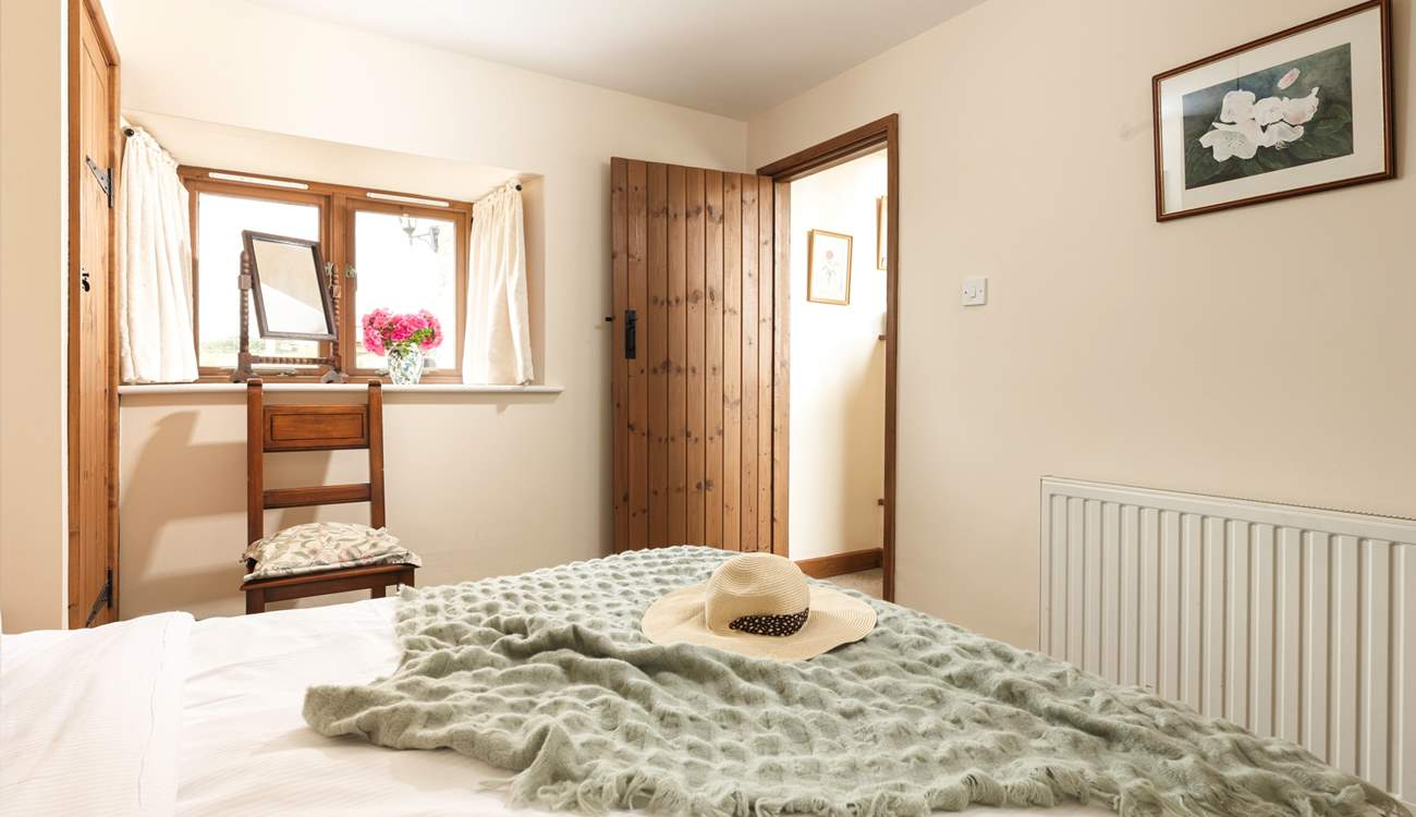 There is a wide window sill, with a make-up mirror - and a view over the courtyard to the fields beyond. 