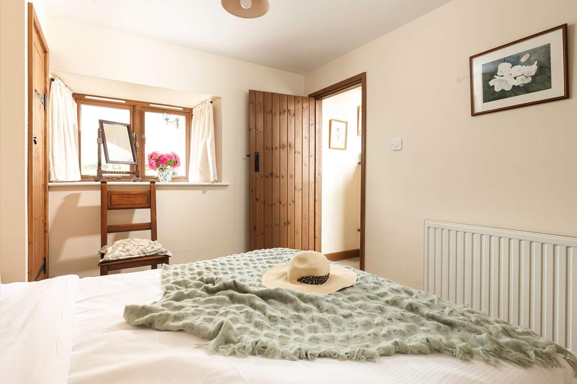 There is a wide window sill, with a make-up mirror - and a view over the courtyard to the fields beyond.