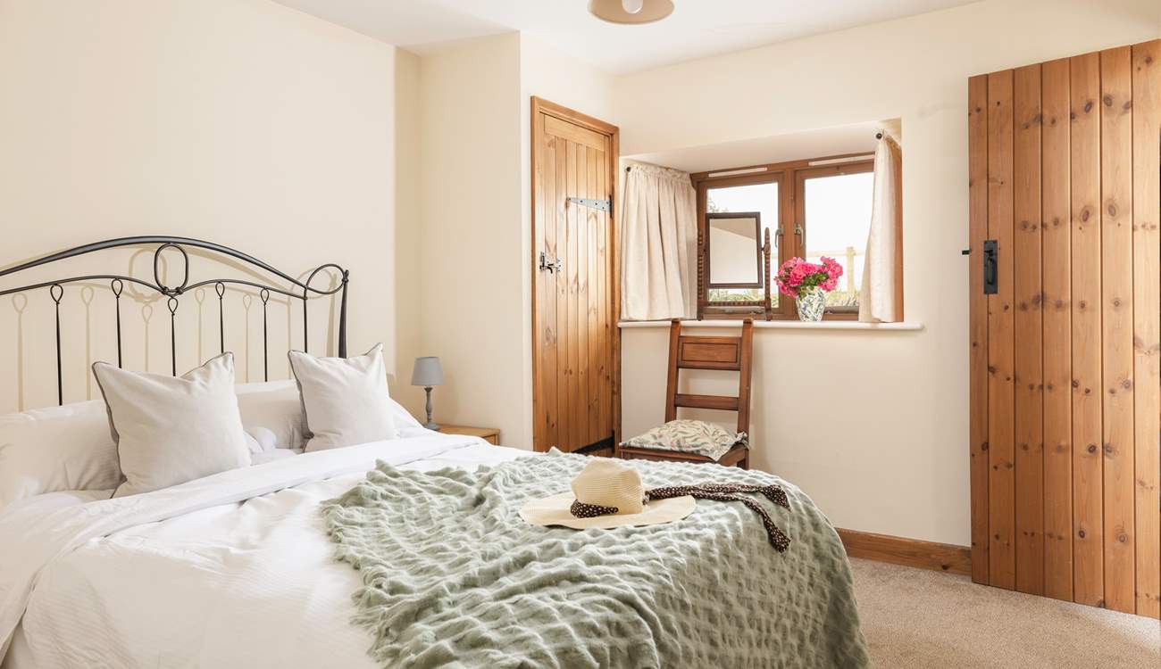 Head down the stairs from the dining-area to the pretty ground floor double bedroom.