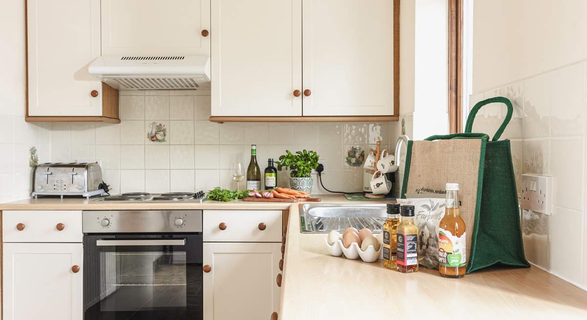 The fully equipped country-style kitchen, with lovely views to the fields behind the cottage.