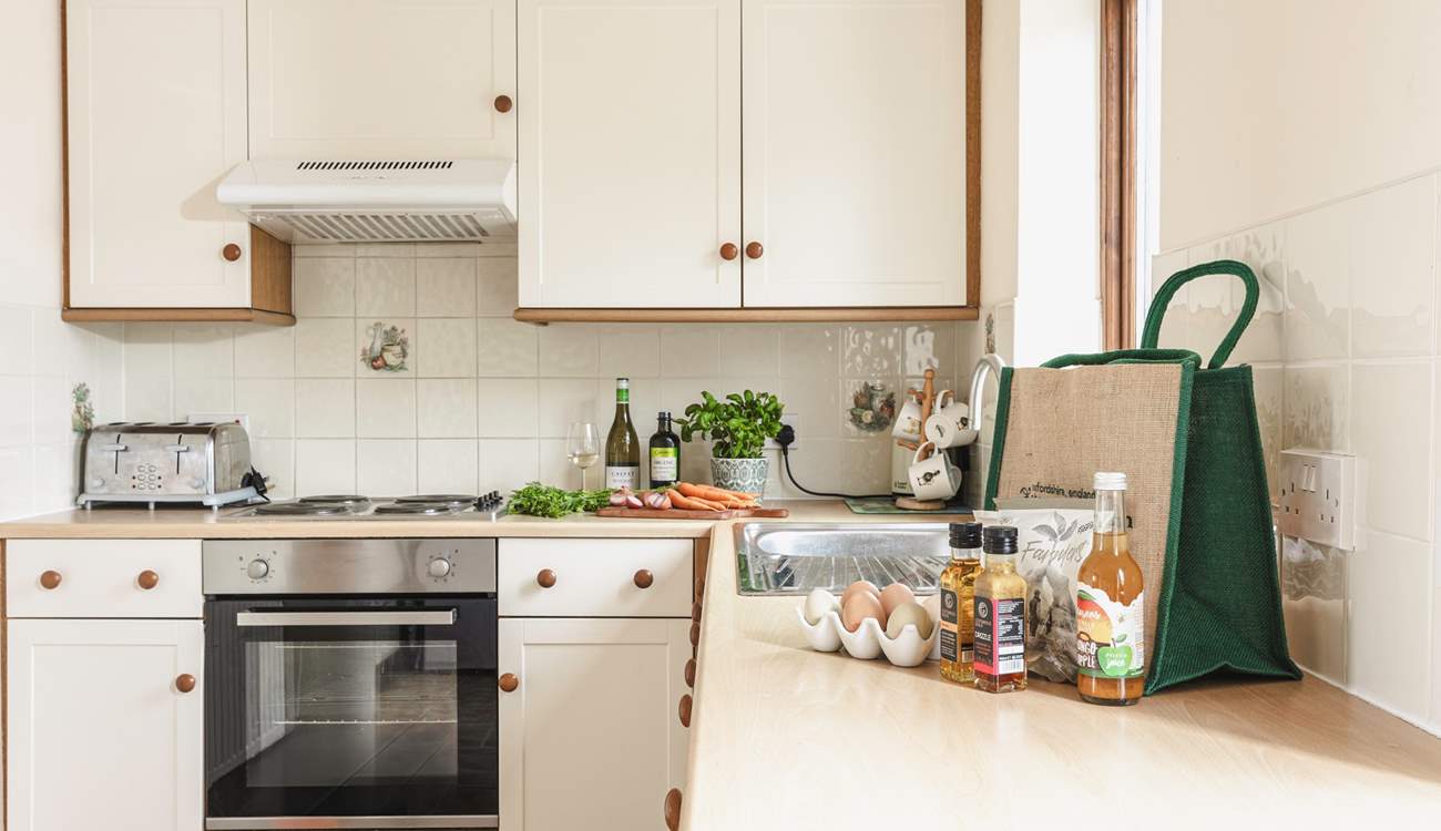 The fully equipped country-style kitchen, with lovely views to the fields behind the cottage.