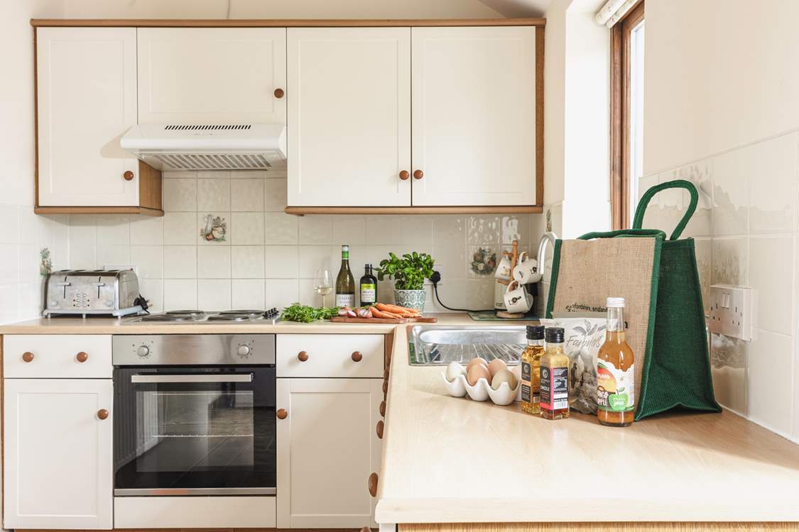 The fully equipped country-style kitchen, with lovely views to the fields behind the cottage.